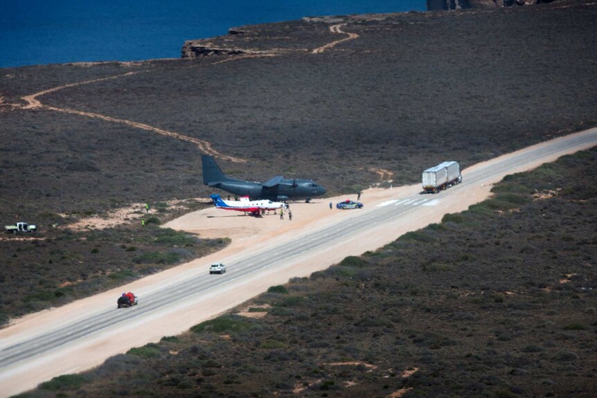 Two planes parked on the side of a remote highway on the Nullarbor as part of a training exercise.
