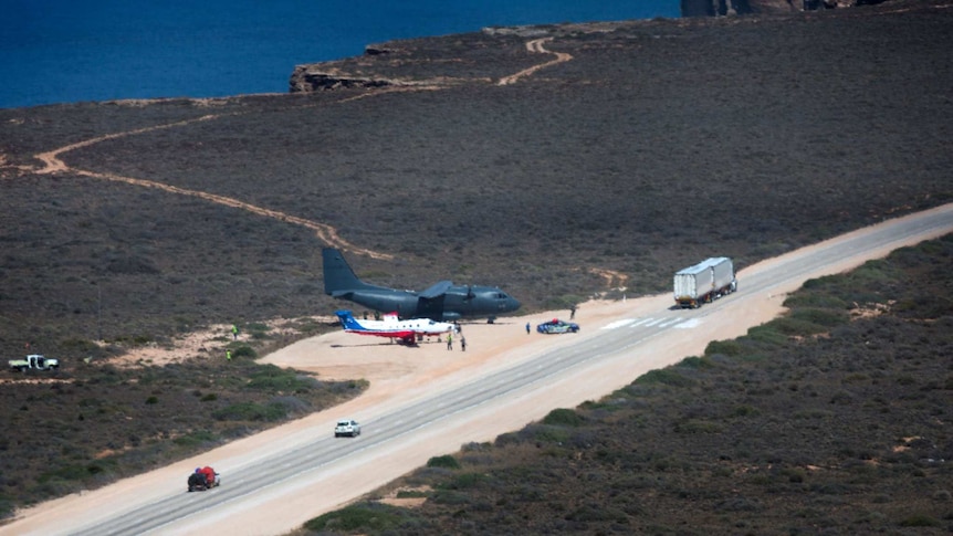 Two planes parked on the side of a remote highway on the Nullarbor as part of a training exercise.