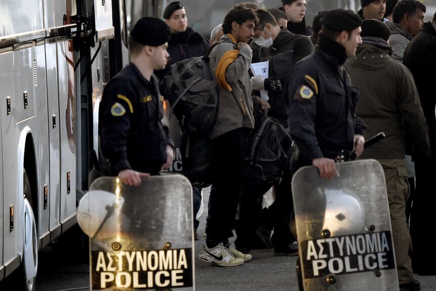 Asylum seekers arrive at the port of Mytilene on the Greek island of Lesbos