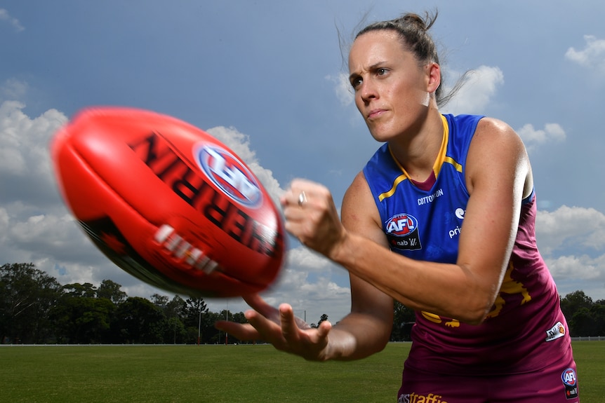 Emma Zielke handballs the footy