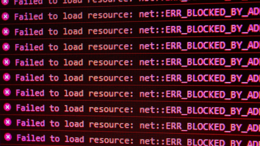 Computer screen with the words "failed to load resource: net:: ERR_BLOCKED_BY_AD" repeated