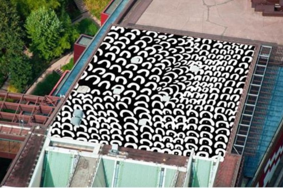 a black and white painting covers the roof of a building
