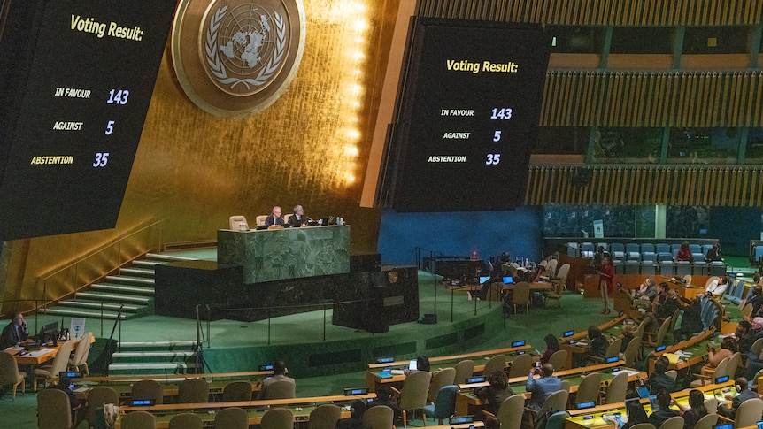 Monitors at the United Nations General Assembly hall display the results of a vote.