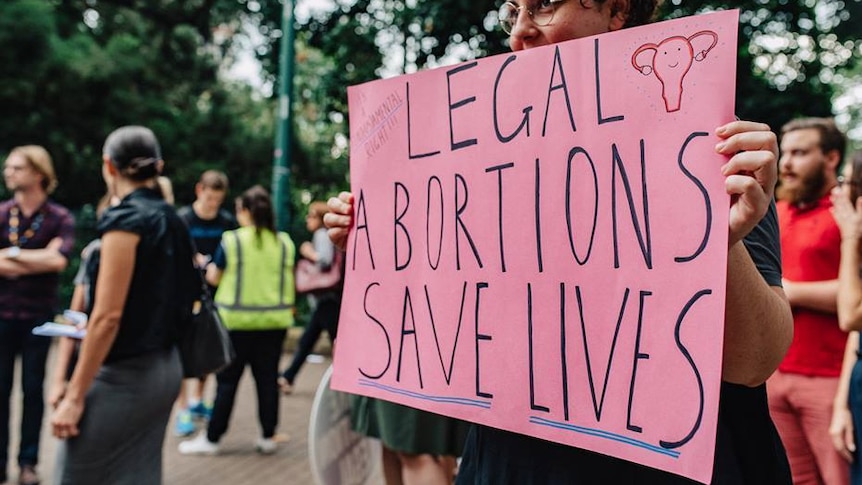 A woman holds a sign at a Brisbane pro-choice rally in May.