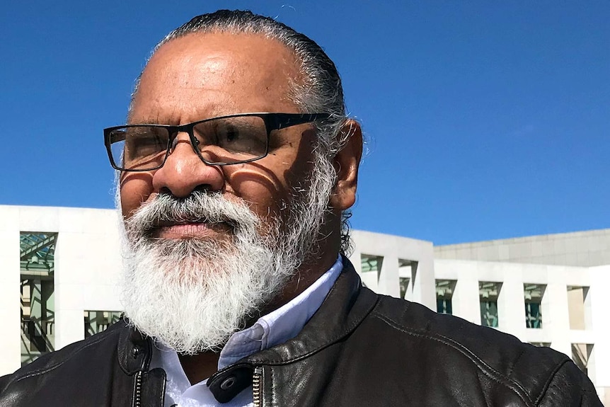 Headshot of Adrian Burragubba standing outside Federal Parliament in Canberra.