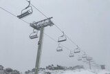 Chair lift and snowy slopes