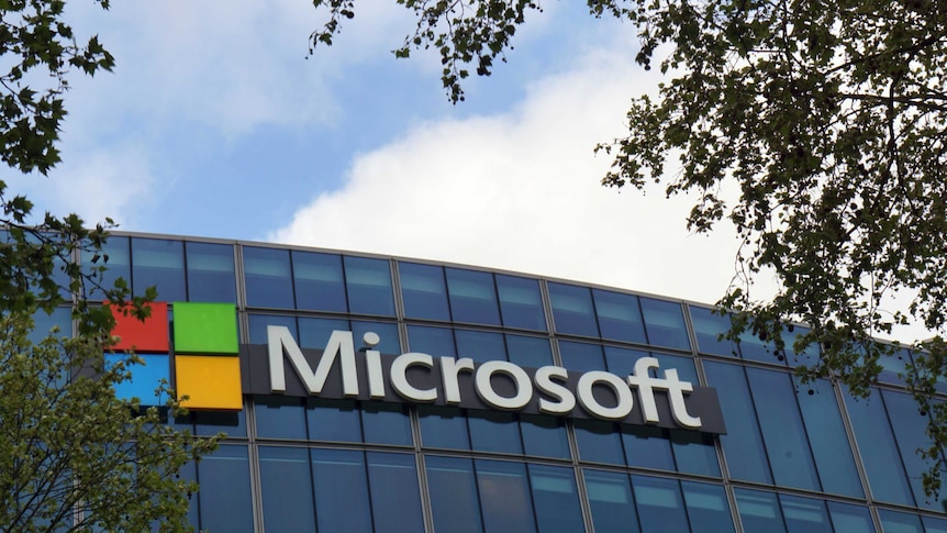 The French headquarters of Microsoft, in Issy-les-Moulineaux, outside Paris. The company logo is on the glass building.