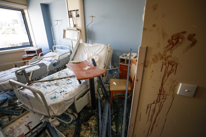 A damaged hospital is seen with blood stains and smashed equipment after a massive explosion in Beirut.