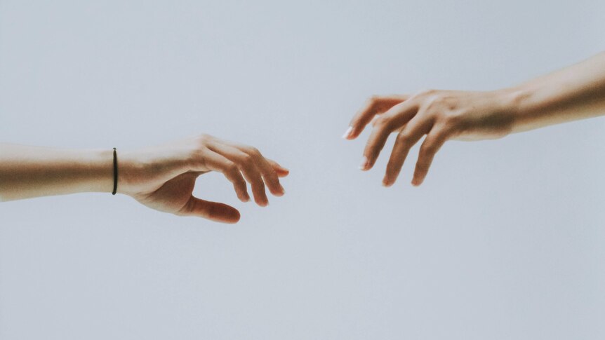 hands reaching towards each other generic