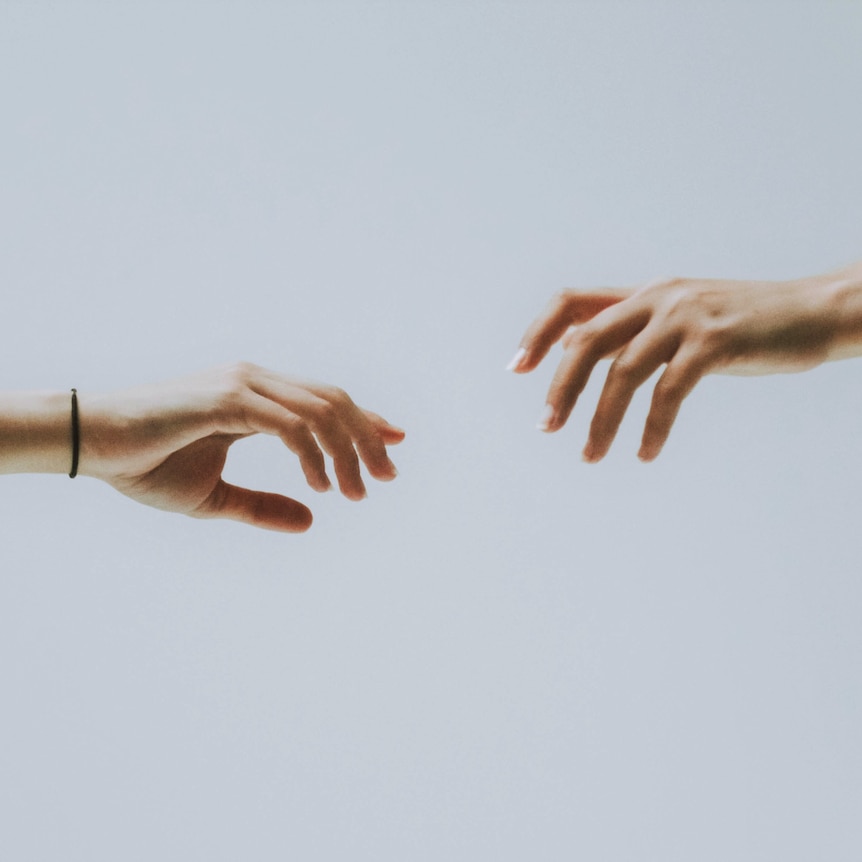 hands reaching towards each other generic