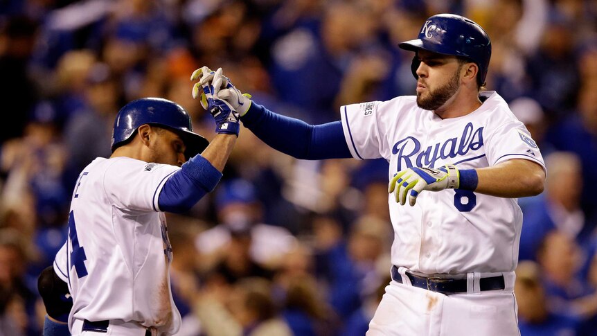 All square ... Mike Moustakas celebrates with Omar Infante after hitting a solo home run