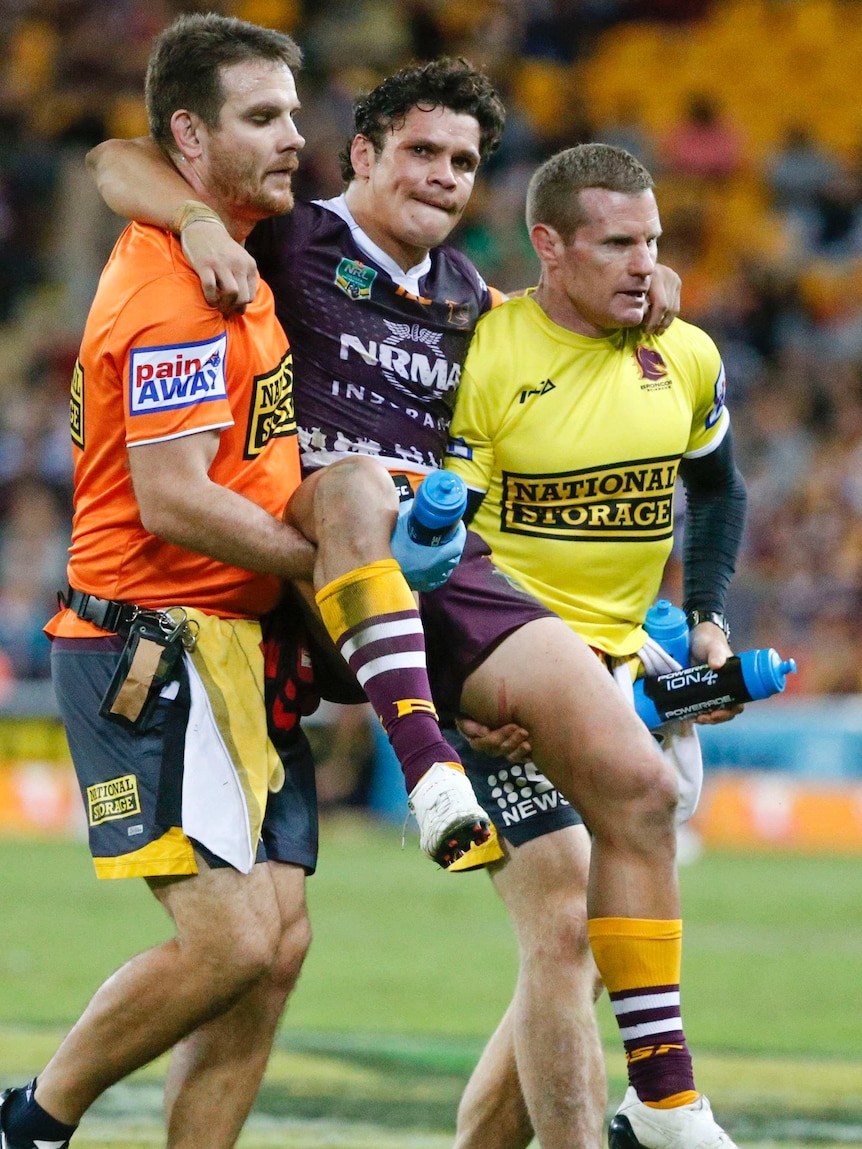 James Roberts is taken from the field with an ankle injury during Brisbane's win over Penrith.
