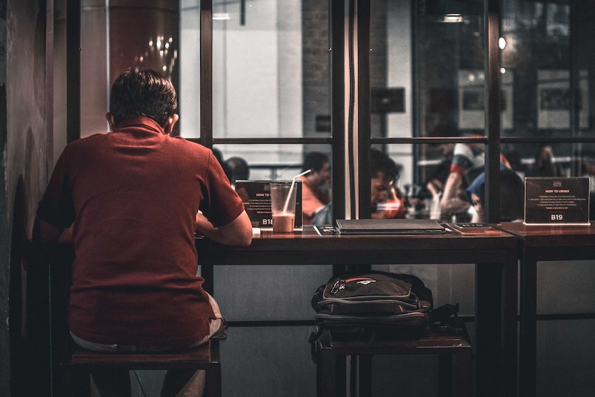 A man sitting at a bar alone.