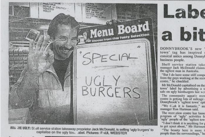 A newspaper article from 1994 with a man holding a sign saying Ugly Burgers