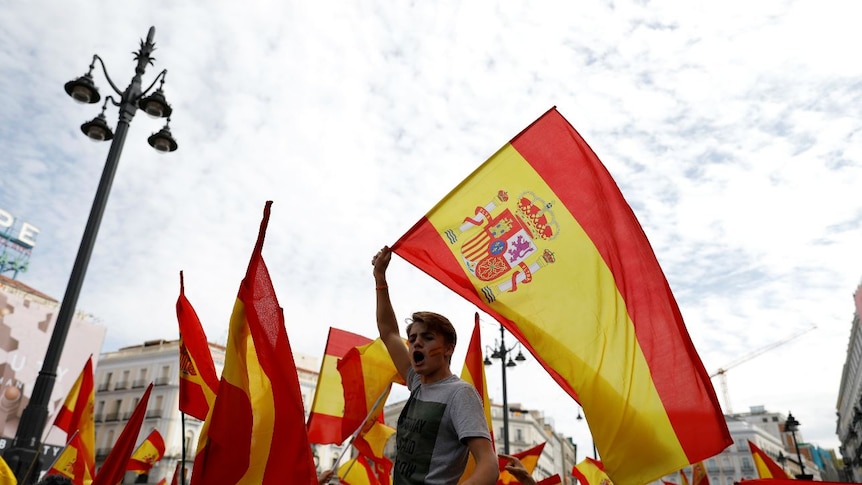 Spanish flags are waved in Madrid in support of a unified Spain.