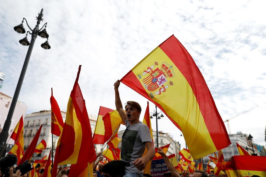 Spanish flags are waved in Madrid in support of a unified Spain.