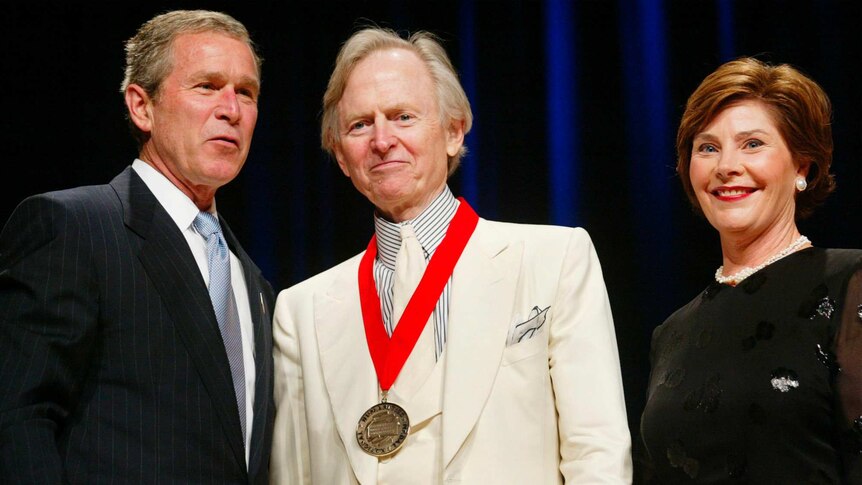 President Bush, left, poses with author Tom Wolfe, centre, and first lady Laura Bush.