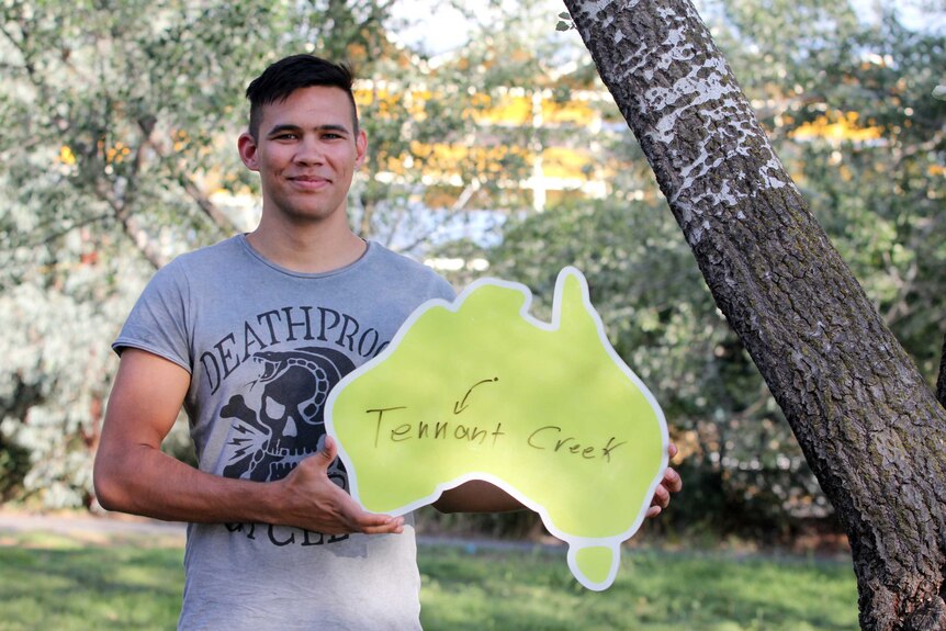 Young handsome man holds map of Australia