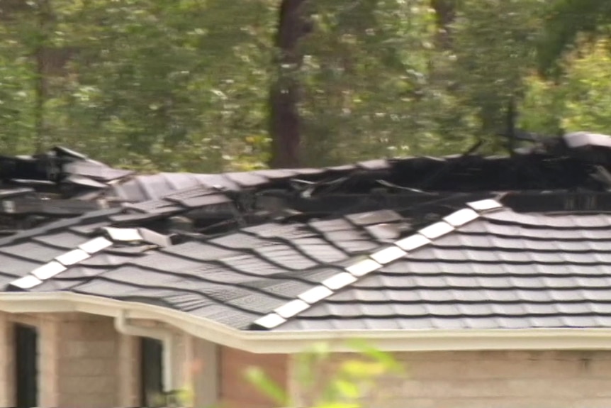 A brick house with a roof collapsed after a fire