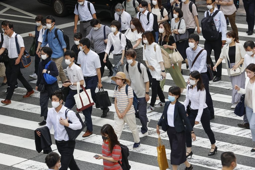 Crowd of people wearing facemasks in Osaka after COVID-19 state of emergency