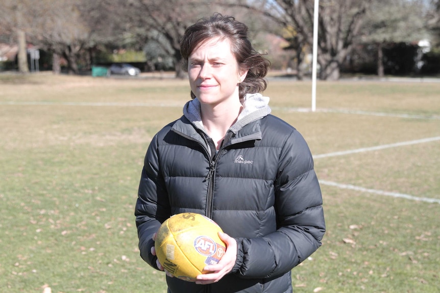 Miranda Debeljakovic at an oval holding a football