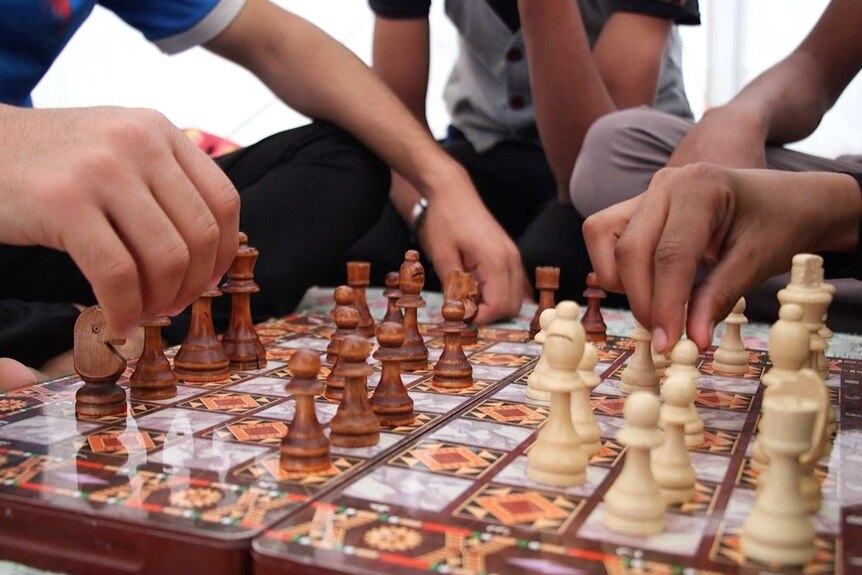 Boys play chess in the Debaga refugee camp in northern Iraq.