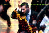 Downcast stockbroker with graphic overlay
