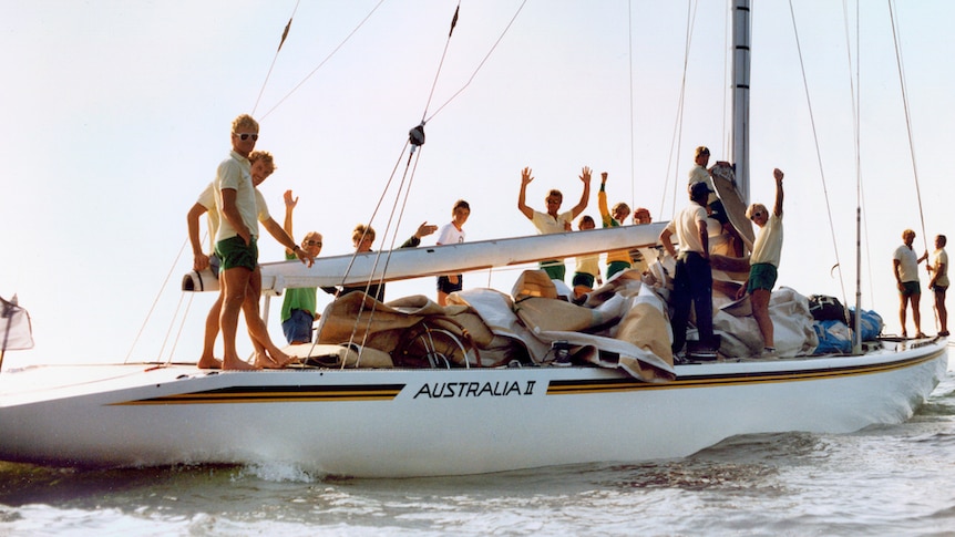 The crew of America's Cup yacht Australia II cheer.