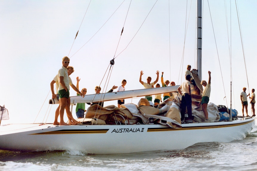 The crew of America's Cup yacht Australia II cheers.