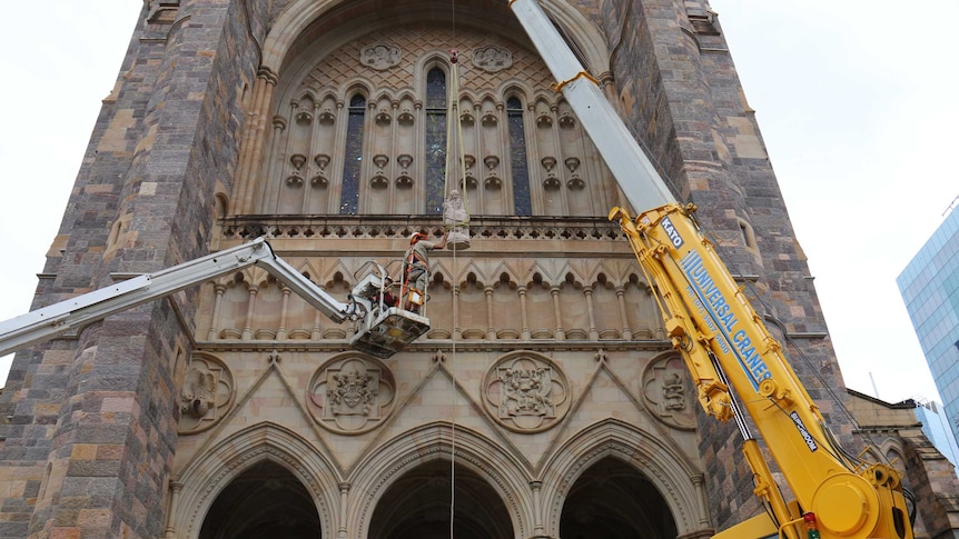 Wisdom being hoisted into place at St John's Cathedral in Brisbane