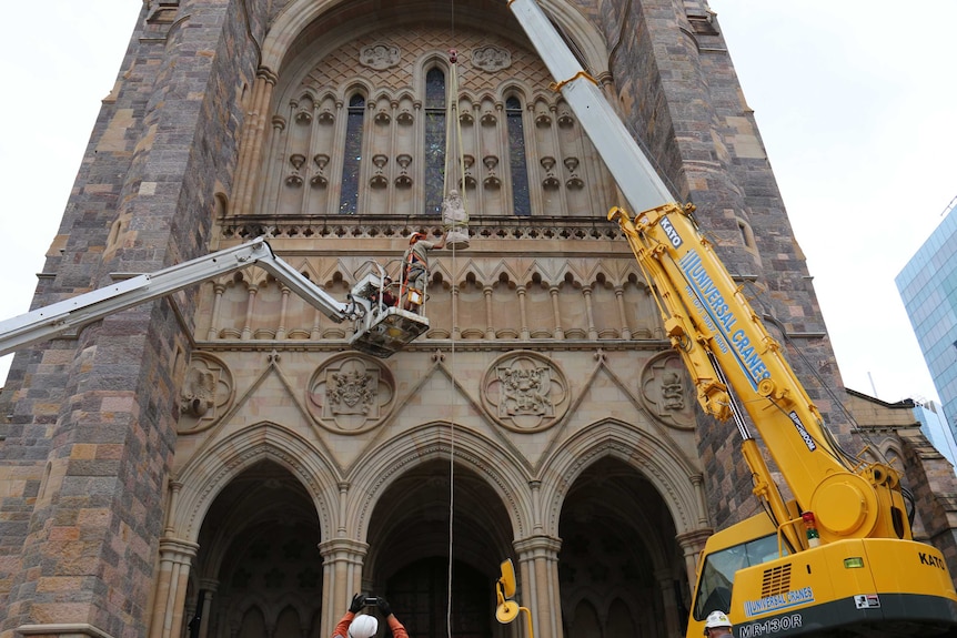 Wisdom being hoisted into place at St John's Cathedral in Brisbane