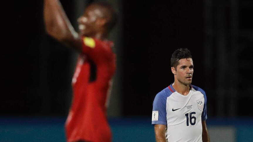 A US player walks off the field after losing to Trinidad and Tobago