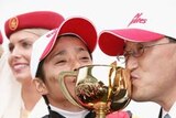 Japanese story: Jockey Yasunari Iwata (l) and trainer Katsuhiko Sumii kiss the Melbourne Cup.