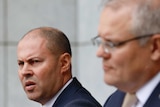 Josh Frydenberg and Scott Morrison stand behind podia in a marble-walled courtyard
