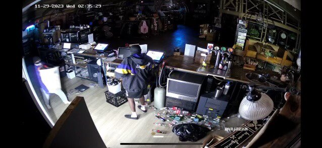 Two people behind a shop counter during a business break-in.