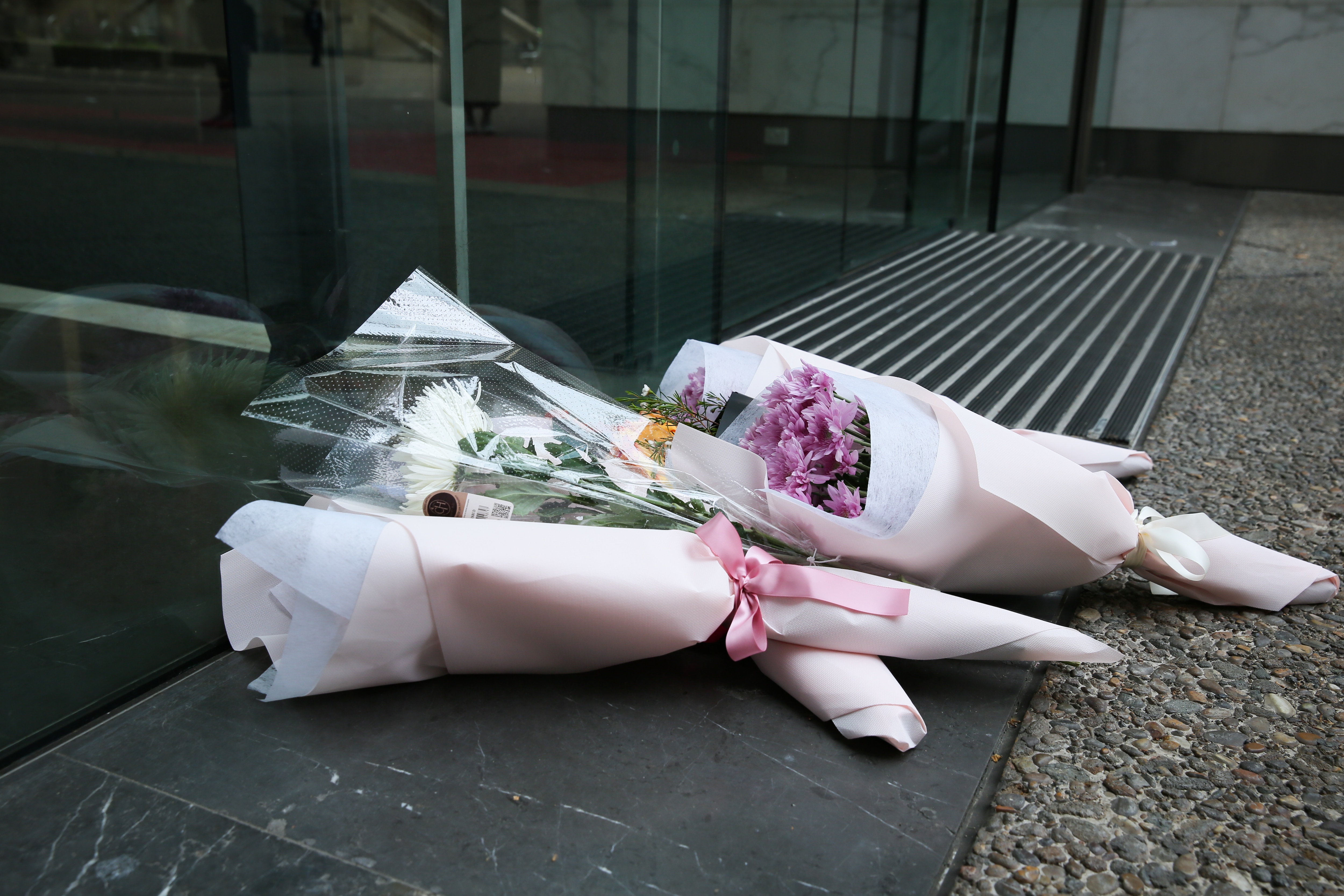 Stacks of flower bouquets laid down in front of St Andrew's Cathedral School