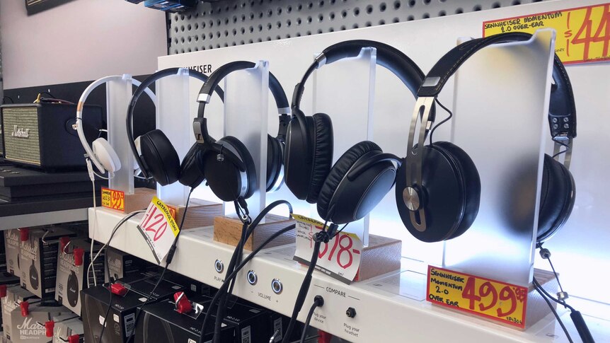 A row of headphones for sale in a shop