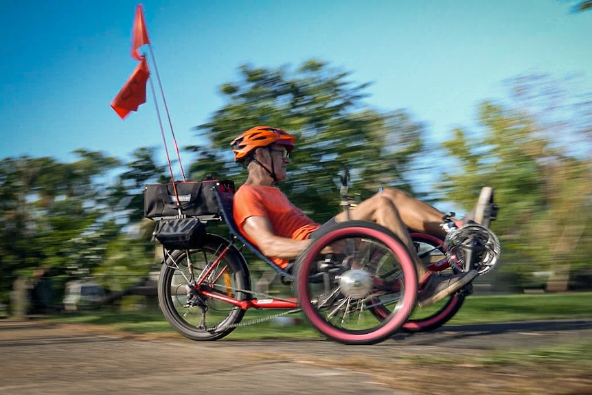 Blurred speed image of man on a recumbent tricycle