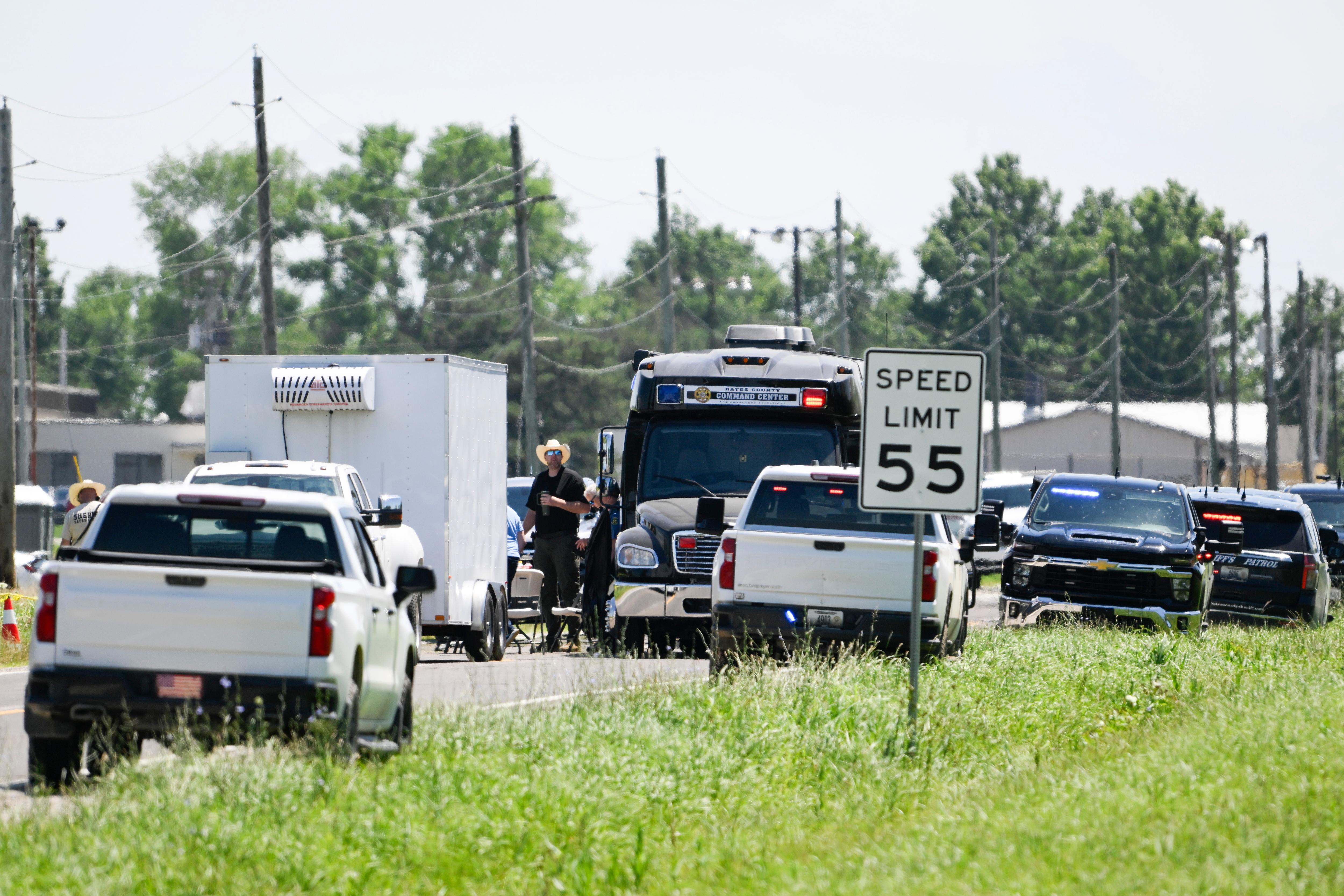The cars of authorities parked on the side of the road 