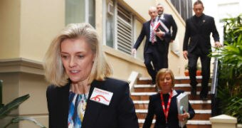 Catherine Brenner walking down some stairs with four people behind her.