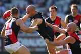 Chris Judd is hauled in by the Essendon defence
