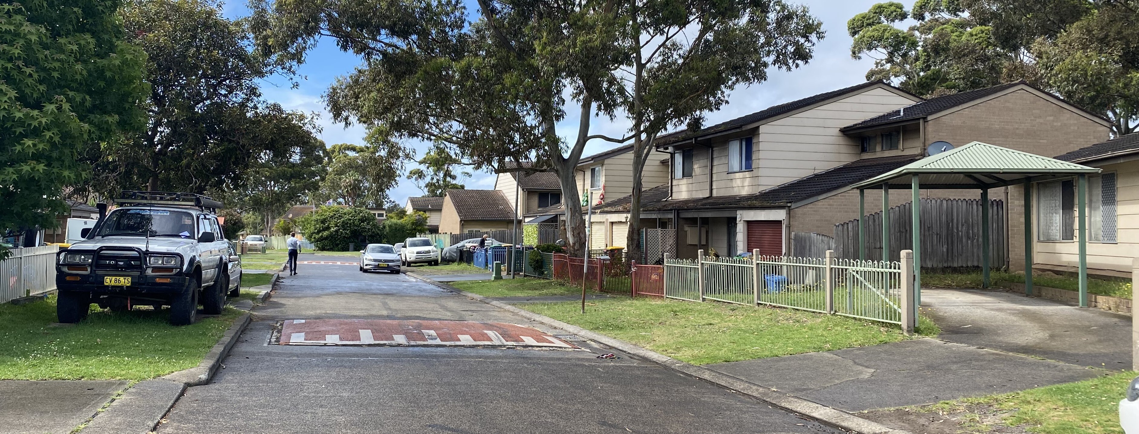 Brick two-storey housing estate with wet road 