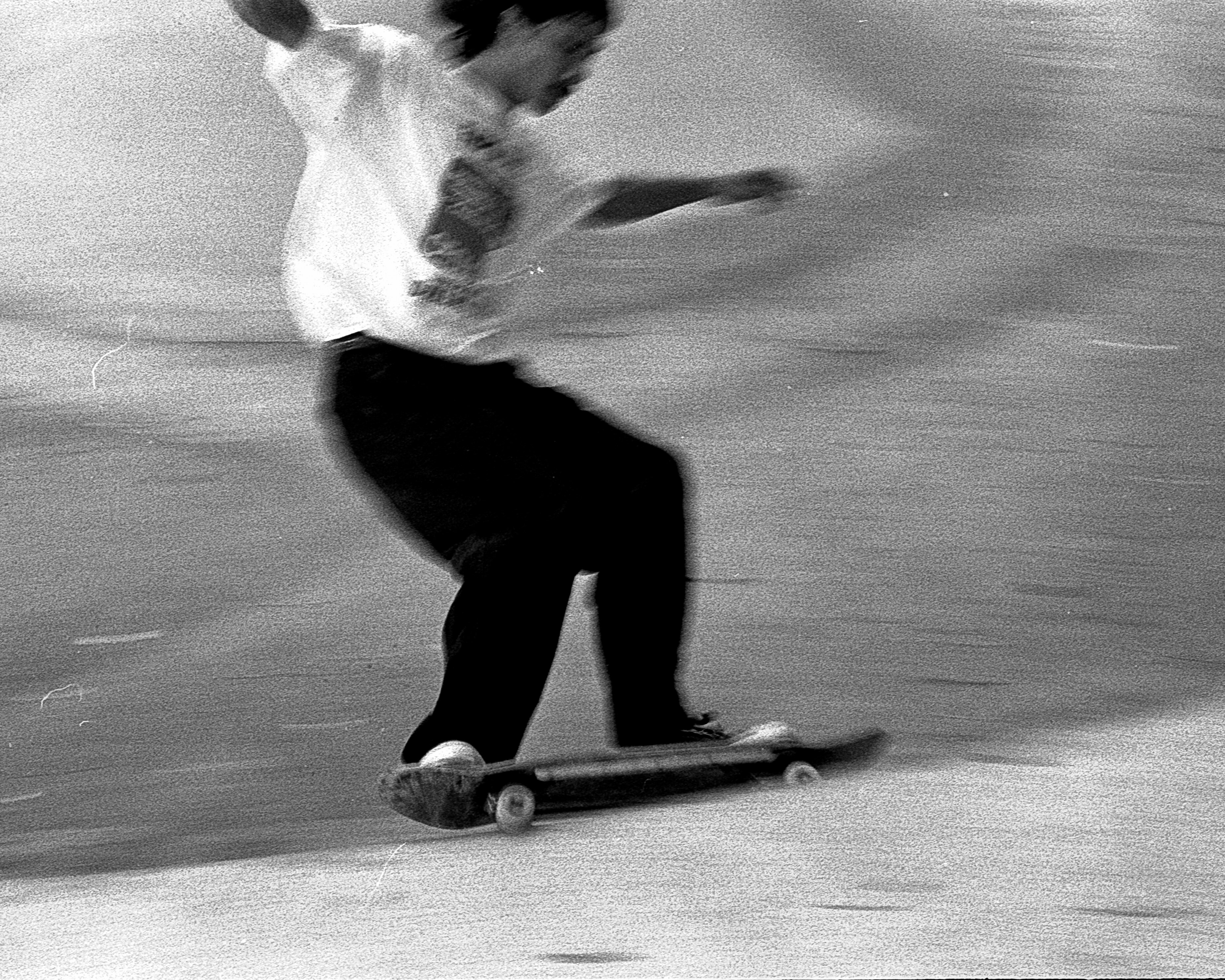 A black and white griany photo of a skateboarder