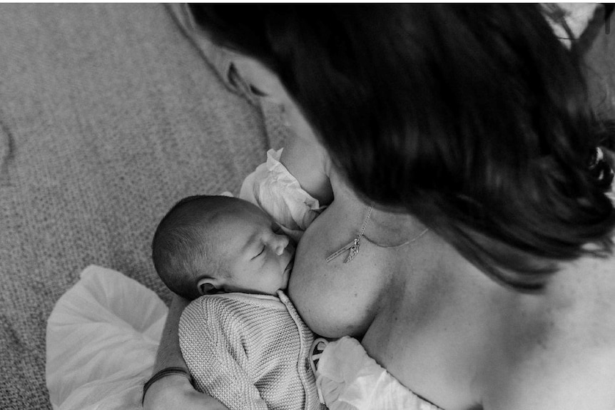 A woman breastfeeding her child in a photo