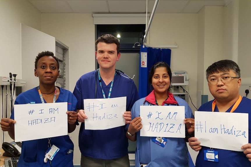 Doctors hold up signs saying #IAmHadiza