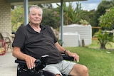 man sits in a wheelchair