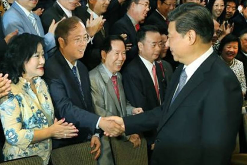 President shaking audience member's hand.