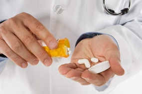 Doctor with pills (Thinkstock: Brand X Pictures)