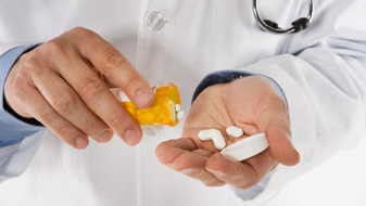 Doctor with pills (Thinkstock: Brand X Pictures)