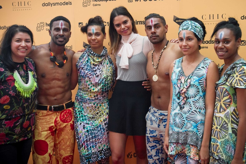 Indigenous supermodel Samantha Phillips stands with a group of aspiring Indigenous models during a fashion show in Cairns.